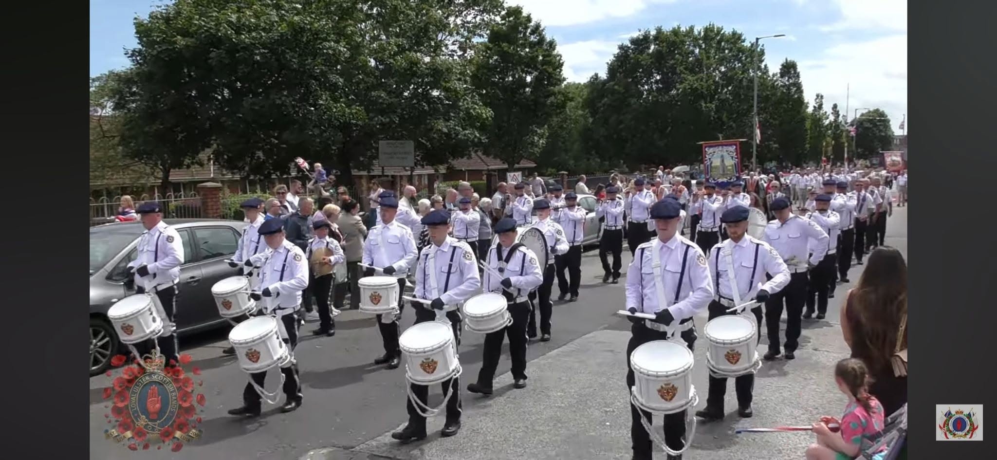 Shankill Old Boys Flute Band marching with drummers in white shirts