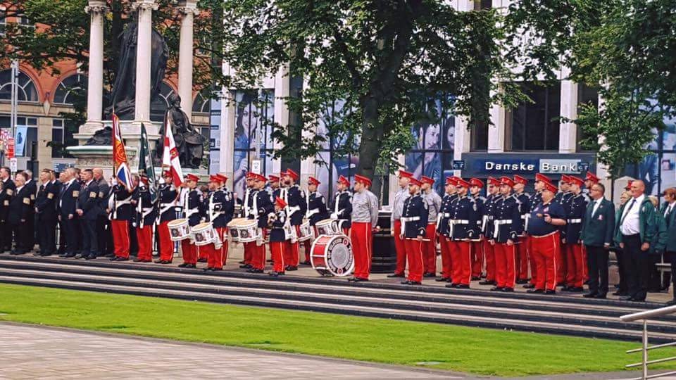 Sons of Ulster Flute Band, Shankill lined up on steps with drums and flags