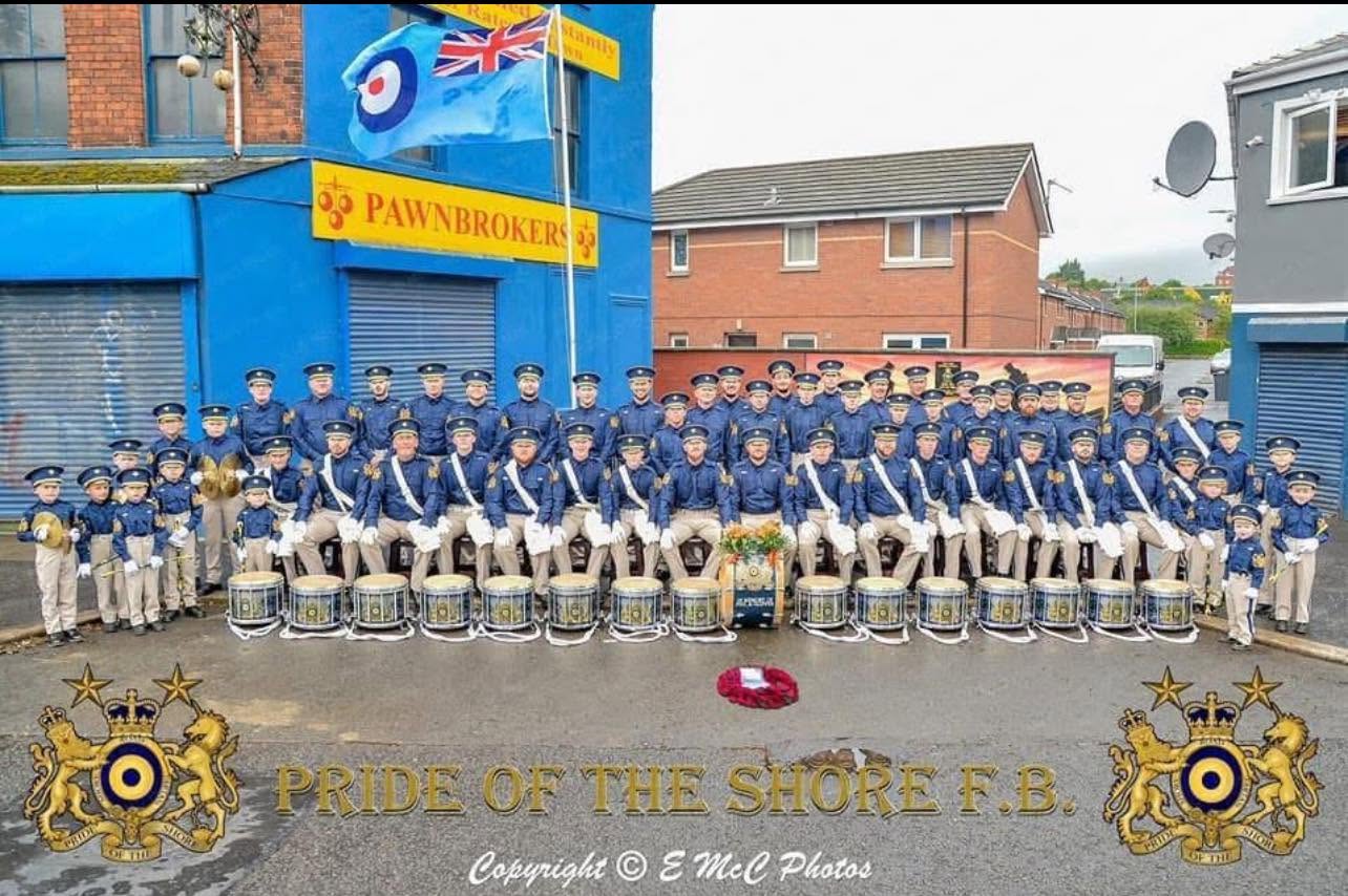 Pride Of The Shore Flute Band group photograph with their drums and band insignia