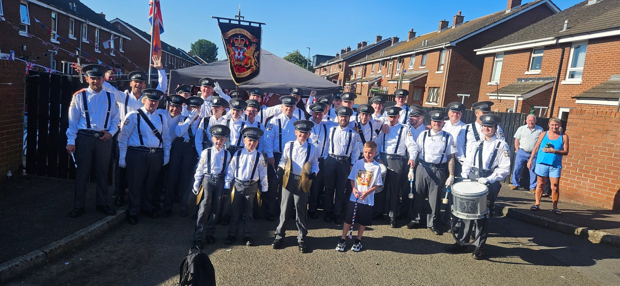 Fairhill Flute Band group photograph with their banner and instruments