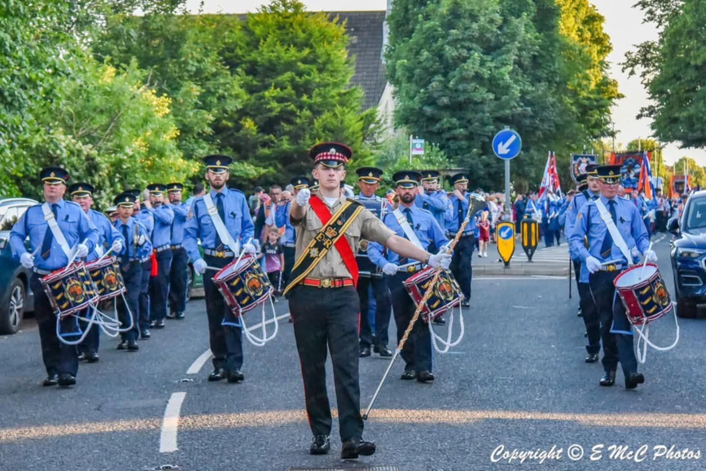 Ballymacarrett Defenders Flute Band marching with a drum major and drummers
